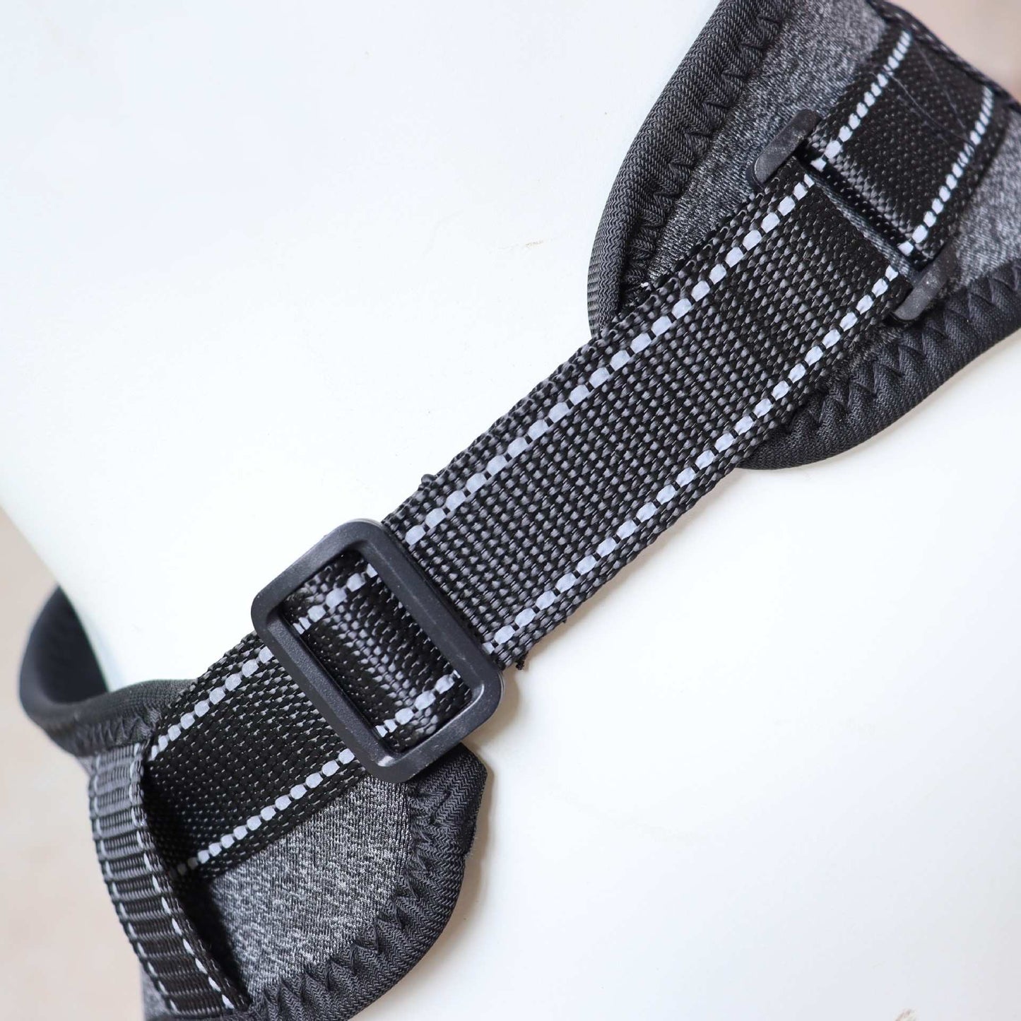 Close-up of a gray and black textured strap with a buckle of Full-Body Split Lifting Support