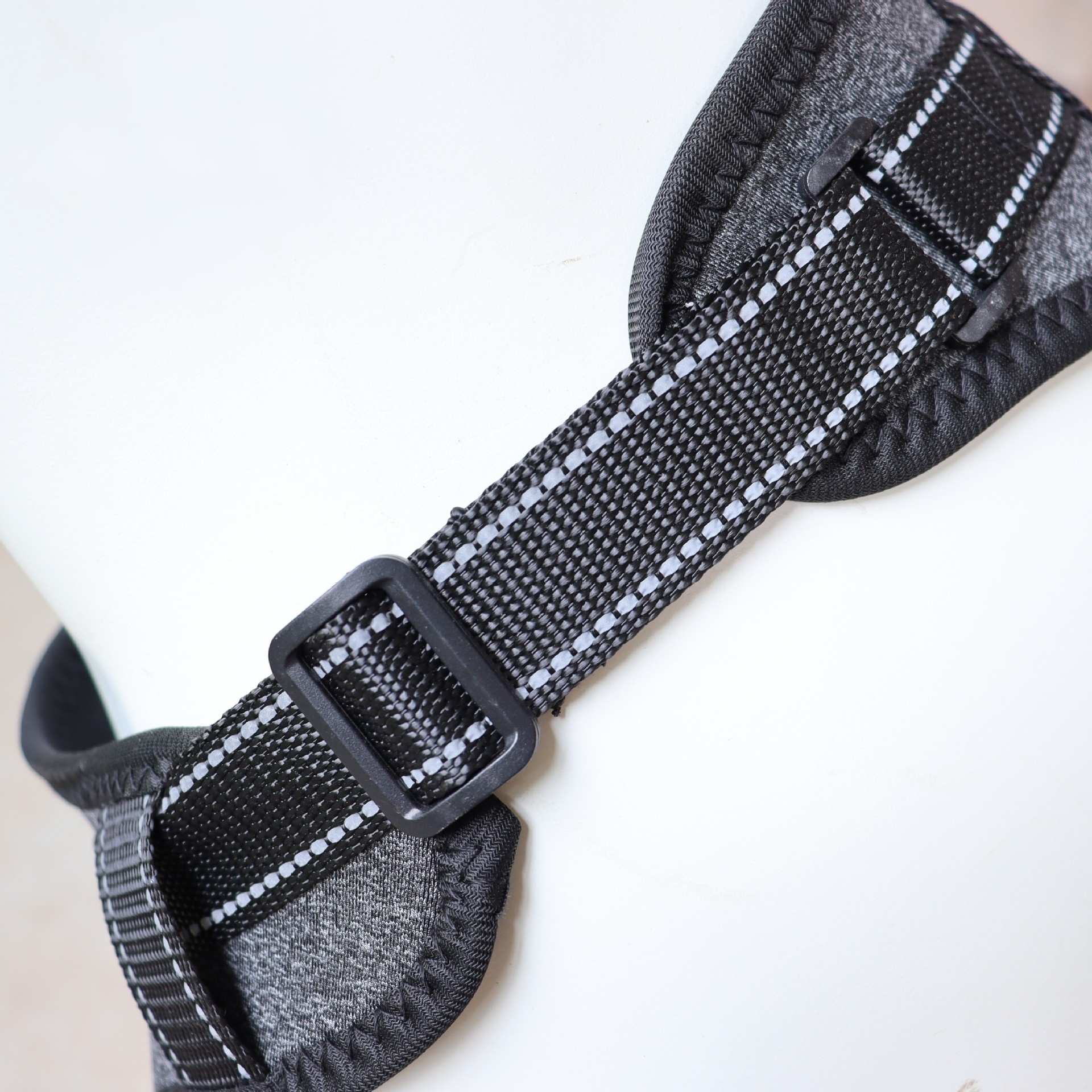 Close-up of a gray and black textured strap with a buckle of Full-Body Split Lifting Support