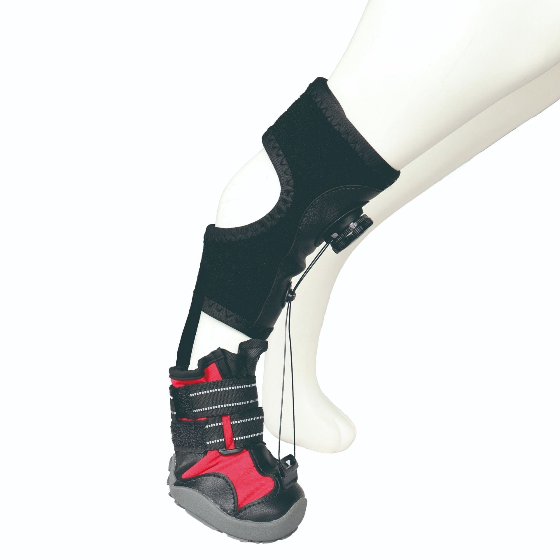 Black and red protective support boot on a white leg mannequin against a white background