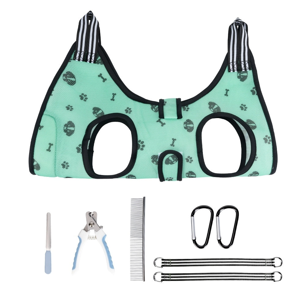 Pet Grooming Hammock Harness with bone and paw pattern, grooming tools, and carabiners on a white background